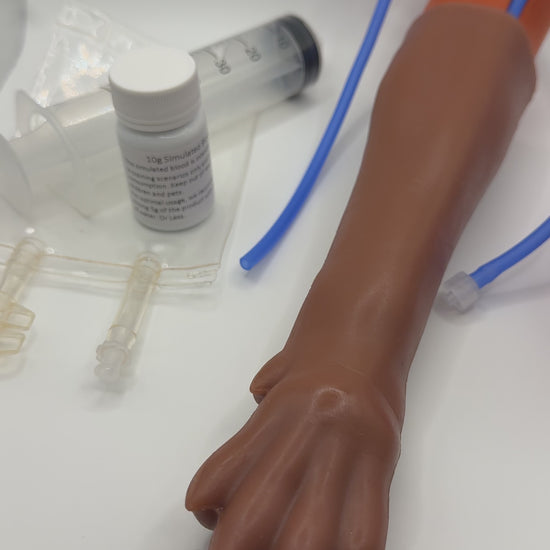 IV Canine Leg Training Kit for vet nurses vet techs trainees students vets with a realistic dog leg training arm, blood fluid bag, syringe, bandages, and small medical 'IV Canine Leg Training Kit' and 'VET NURSE SCHOOL'.